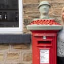 Lynn Clegg with her latest postbox topper to commemorate the 100th anniversary of the Royal British Legion