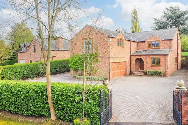 The gated property has a large forecourt and an integral double garage.