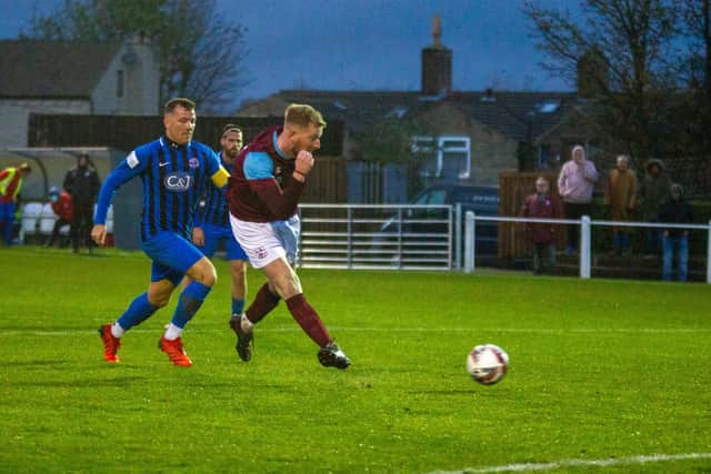 Emley's George Doyle tucks the ball past the Goole AFC goalkeeper to score the winning goal. Picture: Mark Parsons