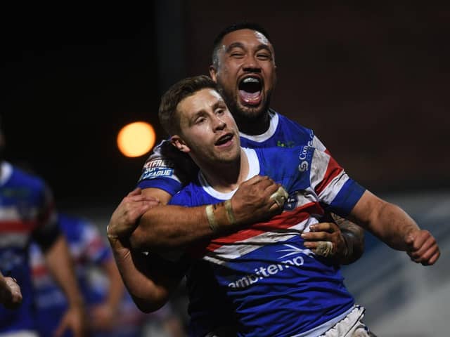 Kyle Wood, front, celebrates a try with Trinity teammate Tinirau Arona. Picture by Jonathan Gawthorpe.