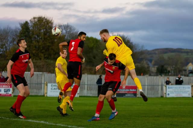 George Doyle heads home Emley's second goal against Silsden. Picture: Mark Parsons