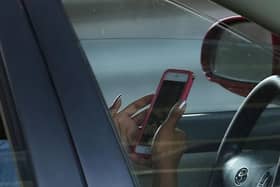Next year, laws will go further to ban drivers from using their phone to take photos or videos, scroll through playlists, or play games.