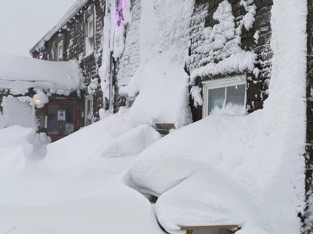 The entrance to the Tan Hill Inn covered by a  snowdrift