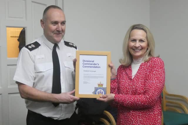 Liz Fairclough being presented with a certificate by Chief Superintendent Mark McManus for her work on the Safe Scheme.