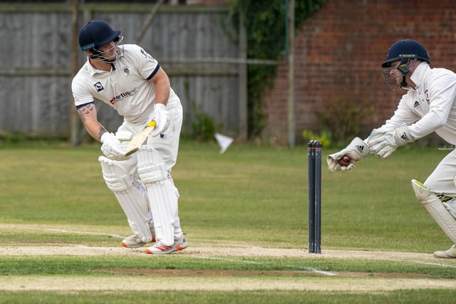 Tom Hemingway looks behind to see West Bretton wicketkeeper Joseph Gott with the ball in his hand and thinking of a stumping.