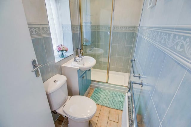 The downstairs w.c. is fitted with a three piece white and chrome suite comprising wide shower cubicle, a vanity wash basin with cupboards under and low suite w.c.