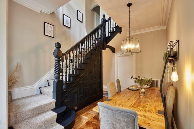 Many of the home’s original features have been retained including the  wooden parquet floor and original, open staircase.