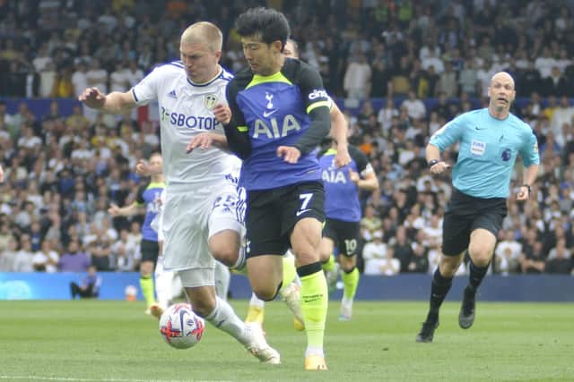 Rasmus Kristensen battles for the ball with Tottenham's Son Heung-Min.