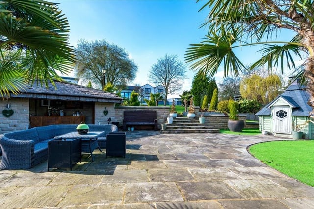 The beautiful gardens with a wide stretch of lawn include numerous seating and entertaining areas.