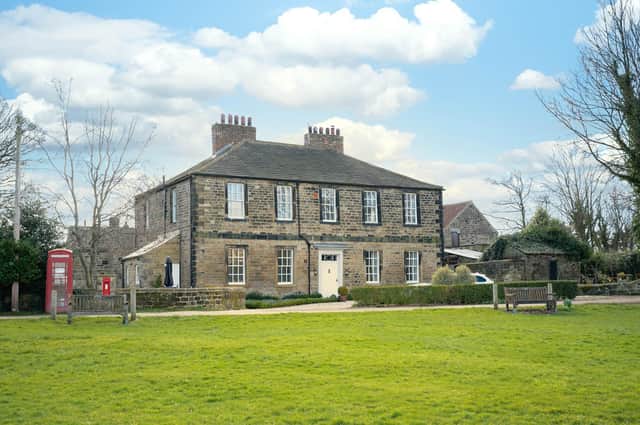 The impressive property stands in a prime spot overlooking the village green.