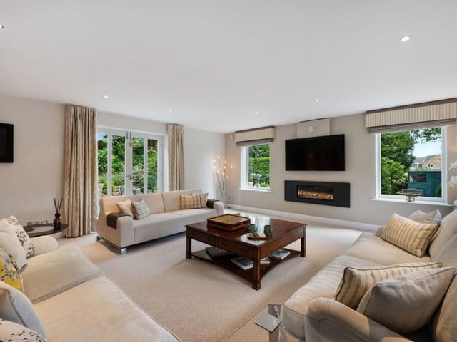 A bright and spacious sitting room, with doors to outside.