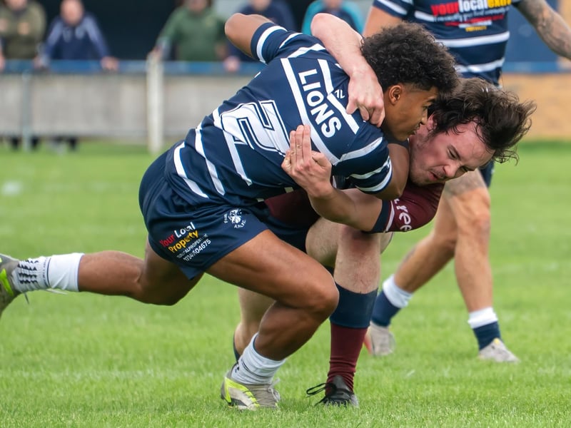 Wingman Rudi Pryce gets hauled down by a Thornhill tackler.
