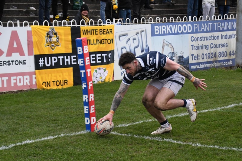 Flying winger Kyle Evans touches the ball down in the corner for a try.
