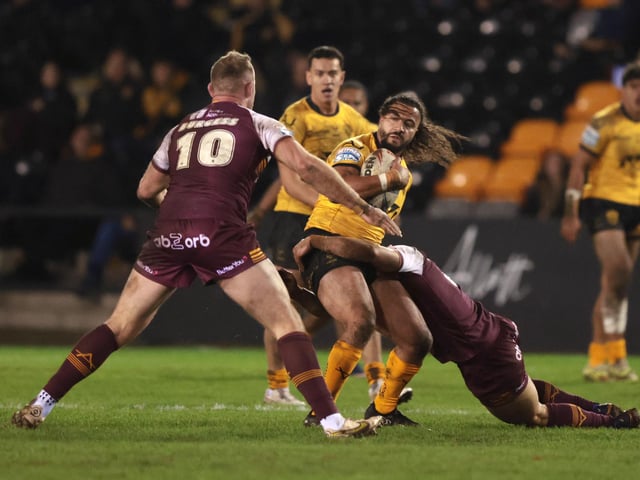 Ashton Golding is tackled by Tom Burgess.