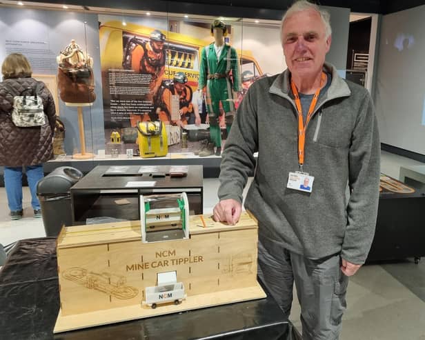 Volunteer Ian Guest with his model mine car tippler. Ian used to work as an electrician and in computing for British Coal. He creates designs on a computer which are then cut out using a laser cutter and 3D printer to make models of mining machinery to aid visitor understanding