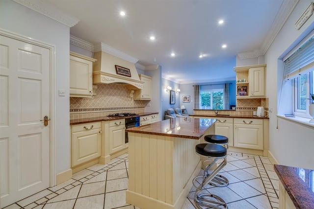 The stunning kitchen with breakfast bar and central island.