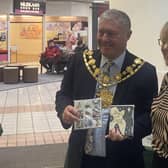 Wakefield's Mayor CounDavid Jones with Card for Good Causes shop manager Jill Farringdon.