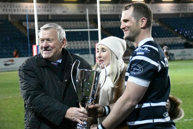Featherstone Rovers captain James Lockwood is presented with the Peter G Fox Memorial Trophy.