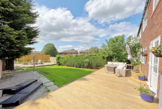 The large, lawned garden has seating and entertaining areas.