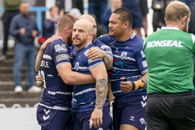 Josh Hardcastle is congratulated on his try by Featherstone Rovers teammates. Picture: Dec Hayes