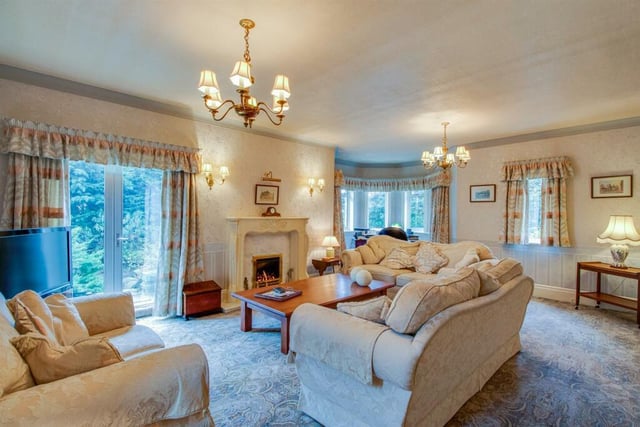 This great living room includes french doors to the side, double central heating radiator and a feature fireplace with ornate surround with marble insert and hearth housing a living flame coal effect gas fire.