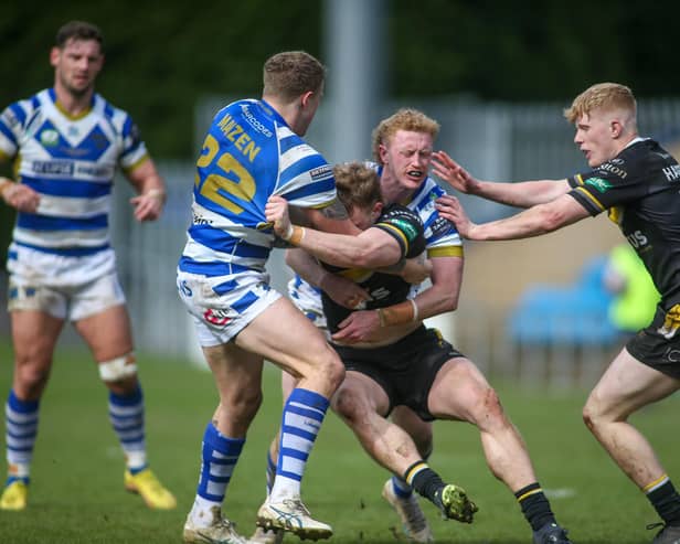 Lachlan Walmsley, scorer of two more tries for Halifax Panthers, helps Jake Maizen to tackle a York player in the 16-6 win.