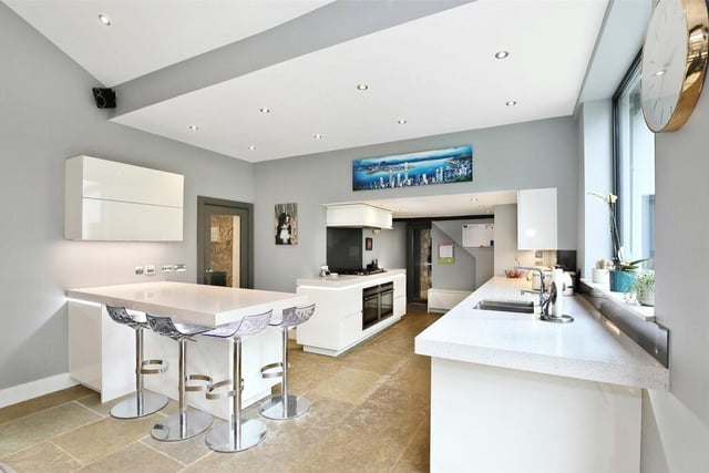 The high spec open plan kitchen with breakfast bar has fitted units with quartz worktops, and integrated appliances.