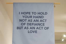 Leonie Cameron’s pertinent textile work takes the form of a protest banner