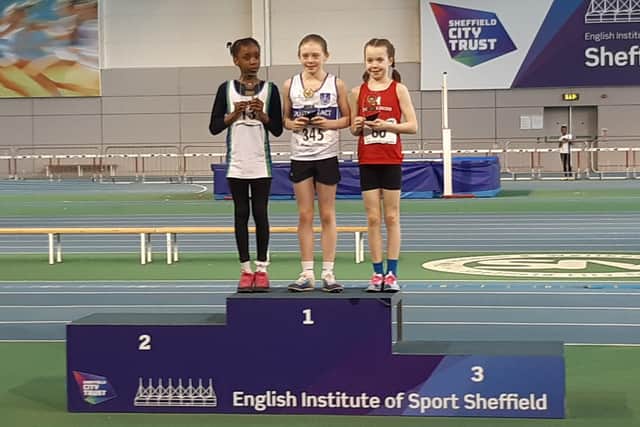 Sienna Lavine on the top of the rostrum after receiving the overall winners award in the Under 11 Girls age group in the South Yorkshire Indoor Athletics Series.