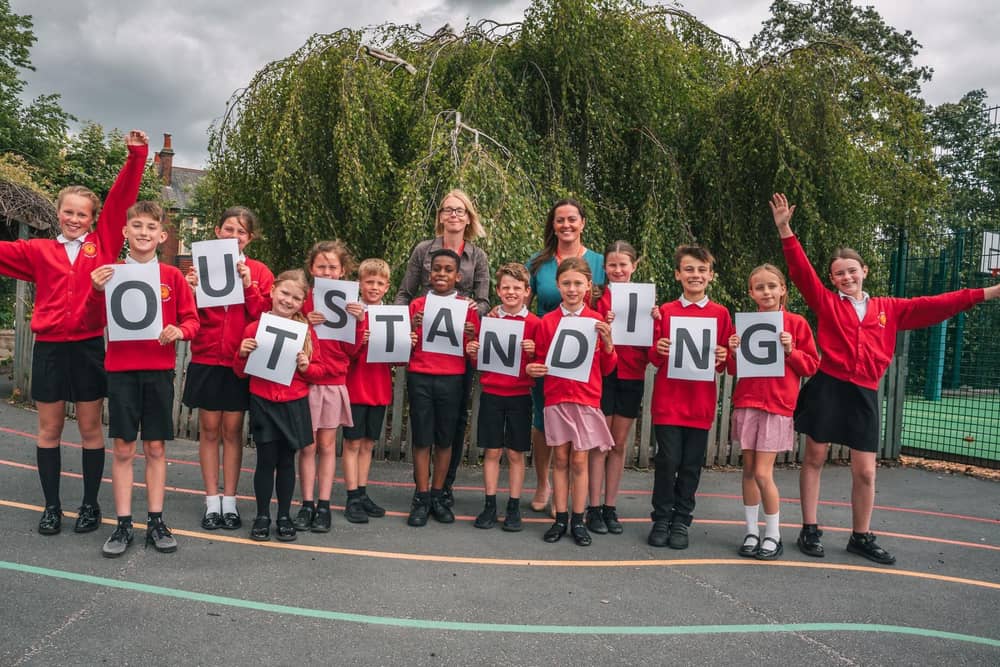 Headteacher Kerry Partington (back, right) and Deputy Headteacher, Rebecca Mohebi with pupils celebrating the Ofsted report at Southdale CofE Junior School in Ossett.