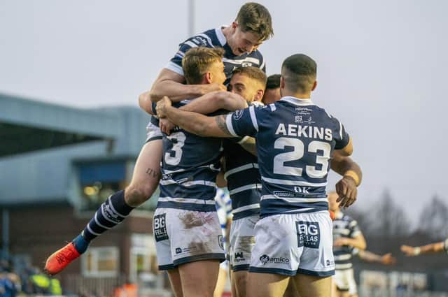 Featherstone Rovers celebrate scoring one of their eight tries against Halifax Panthers.