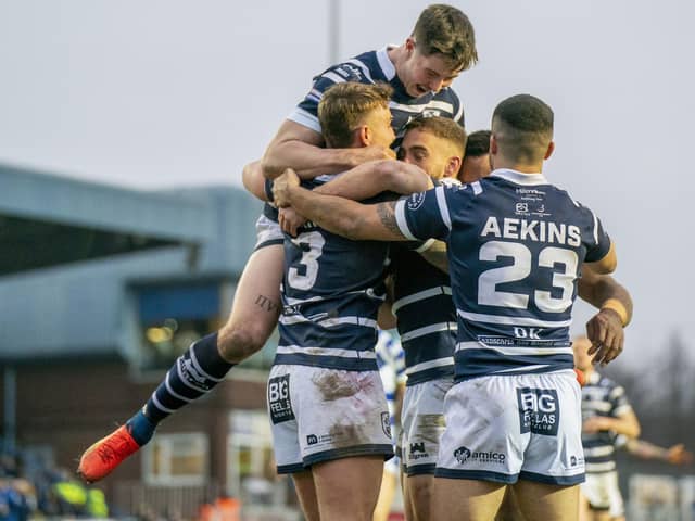 Featherstone Rovers celebrate scoring one of their eight tries against Halifax Panthers.