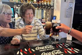 Christina Hagan, 79 and a resident at Newfield Lodge Care Home, pictured pulling her first pint since she left bartending 40 years ago
