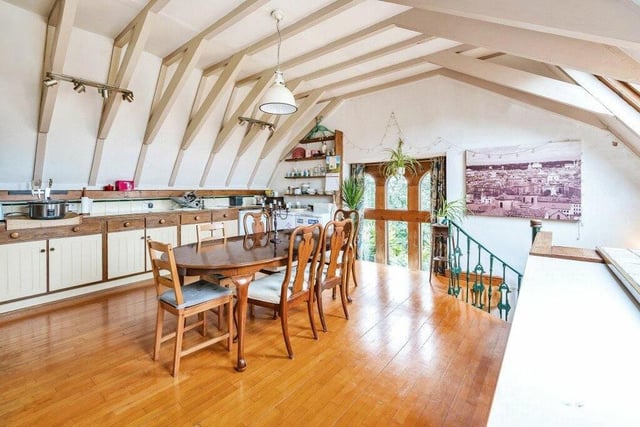Natural light floods through arched windows to the kitchen with diner.