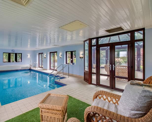 The property's stunning indoor heated pool with seating area, that has access from the conservatory.