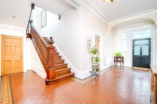 The very spacious hallway with impressive staircase.