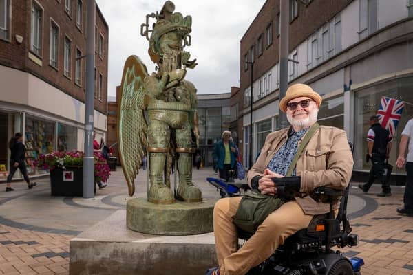 Artist Jason Wilsher-Mills pictured with his 'Amazon love God' statue