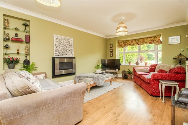A bright and spacious lounge with bay window, and wall mounted gas fire.