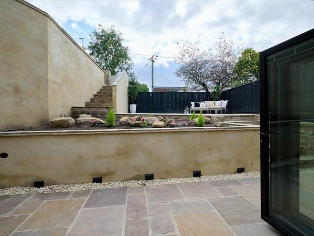 Outside, soak up the sunshine on the two spacious, stone patios to the front and rear of the home. The front patio has raised beds, in which to grow your own plants, and is illuminated by external lighting making it perfect for relaxing or entertaining family and friends.