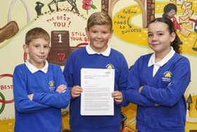 Year 6 pupils Elijah Budby, Lincoln Berry and Amelia Denny celebrate Normanton Junior Academy's Good rating by Ofsted. Picture Scott Merrylees