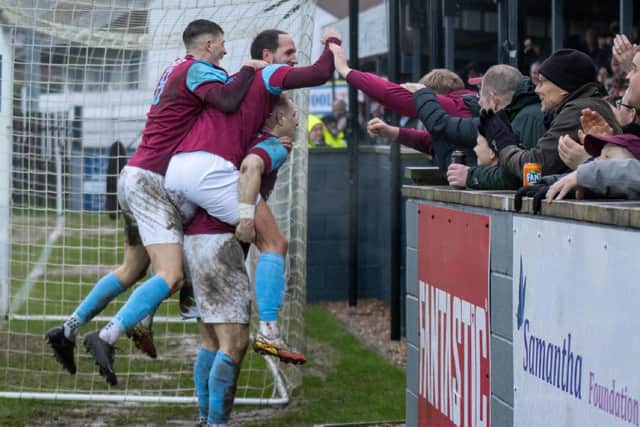 Emley players Joe Clegg and Tom Haigh fans celebrate James Walshaw's goal. Picture: Mark Parsons
