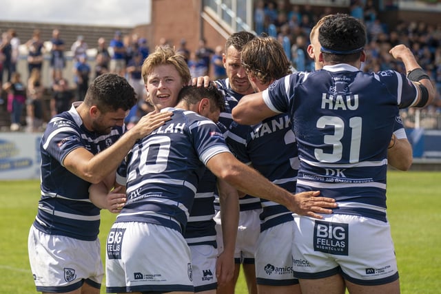 Mark Kheirallah celebrates his try with his Featherstone Rovers teammates.