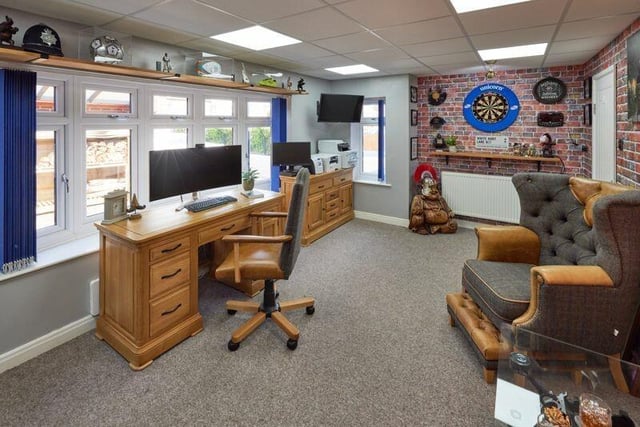 The office can double as an entertainment space, with a built-in bar and wine rack, and access to the garden.