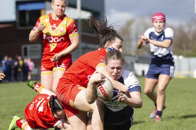 Katie Evans dives over for a try. Pictures: John Victor