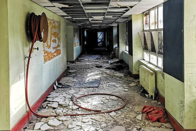A mixture of schoolwork and rubble cover the floors.