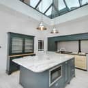 The stunning modern kitchen, with central island and roof lantern.