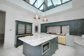 The stunning modern kitchen, with central island and roof lantern.