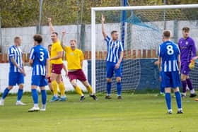 James Walshaw raises his hand to celebrate scoring a goal for Emley against Frickley Athletic.