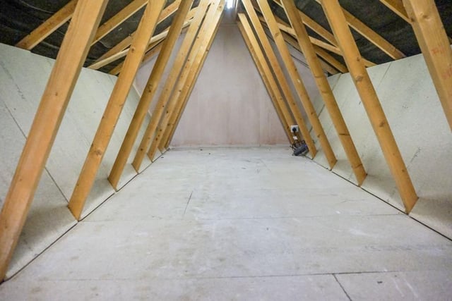 The boarded loft has a clear and spacious area for storage.