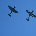 Spitfire planes fly overhead. (Pic credit: Glyn Kirk / Getty Images)